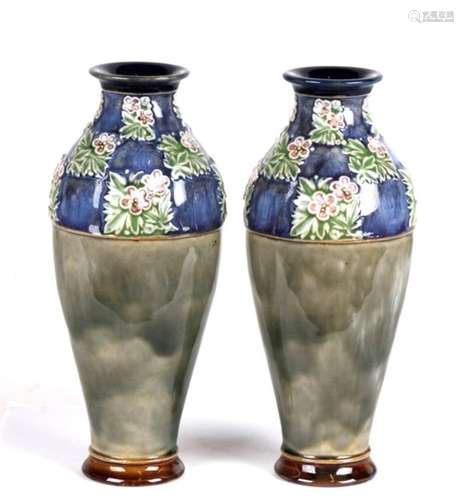 A pair of Royal Doulton stoneware vases decorated with flowers, impressed 'LB' and 'MB' to the