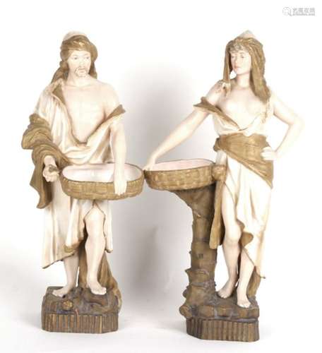 A pair of Austrian Ernst Wahliss Turn Pottery Eastern figures, the man holding a basket and a