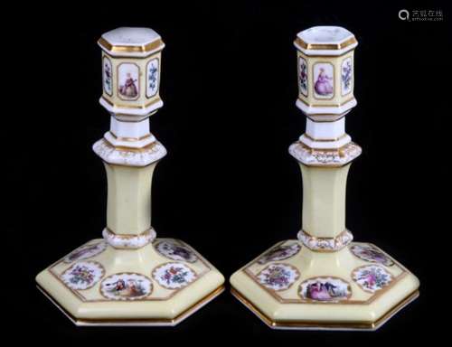 A pair of mid 19th century Paris porcelain candlesticks, a primrose yellow ground with enamelled