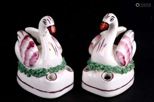 A pair of mid 19th century pink lustre swan quill holder inkwells, each depicted seated upon a nest.