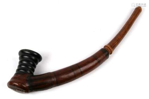 Africa/ Tribal Art. A pipe with black clay bowl of ring form and having a tooled leather body and