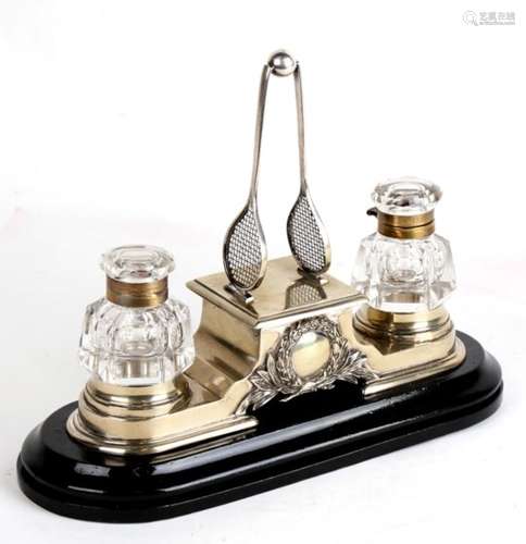 A Victorian novelty tennis related desk stand with central rackets and ball flanked by two glass ink