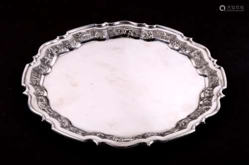 An Indian sterling silver salver, the rims decorated with embossed and chased farming scenes,