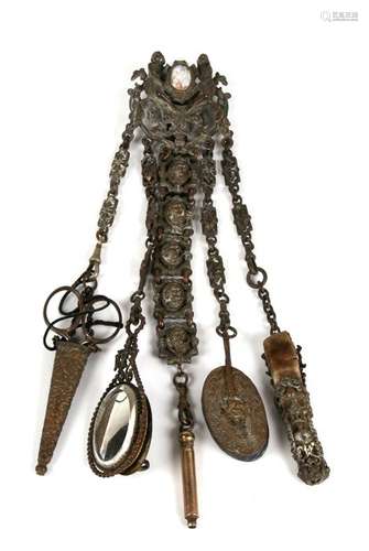 A fully loaded Victorian chatelaine with painted enamel plaque; scissors, aide memoire, mirror,