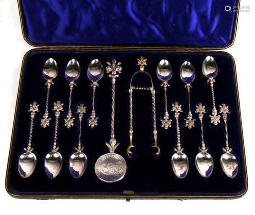 A cased set of 13 silver spoons and tongs, the largest with coin bowl made from 1712 tollero. This