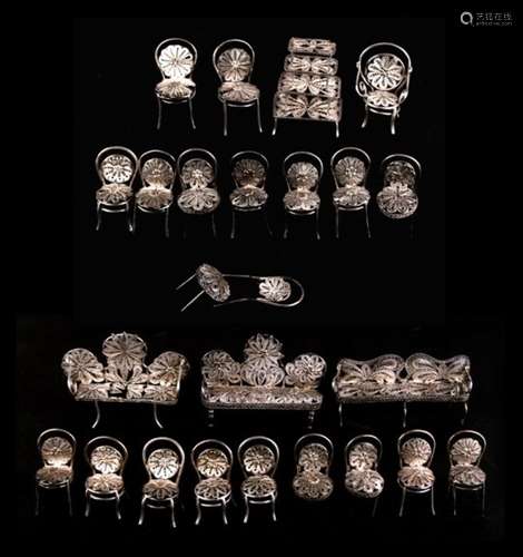 A collection of continental silver (unmarked but tested) filigree miniature furniture. (25)