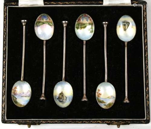 A set of six silver and enamel coffee spoons, the enamel bowls decorated sea scape scenes,