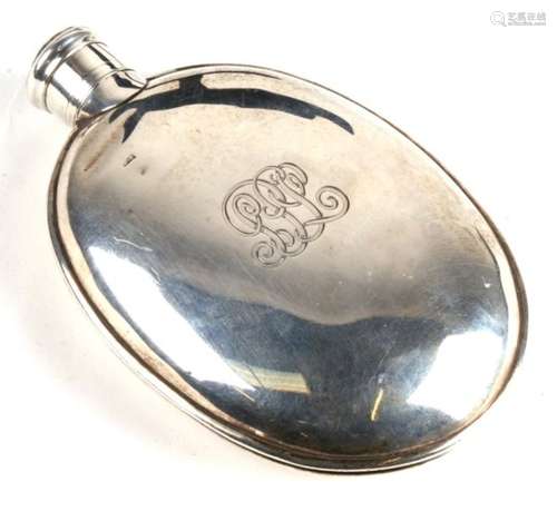 An oval silver hip flask, initialled, with indistinct London hallmark. 128g. 12.5cm (5 ins) high