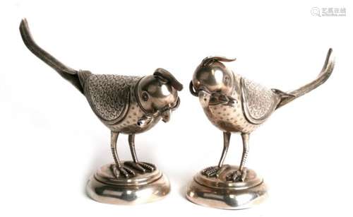 A pair of Eastern silver rosewater sprinklers in the form of parrots with flower buds in their