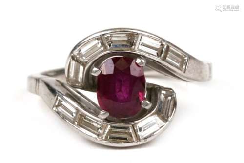 An 18ct white gold (tested) ruby & diamond ring set with a large central oval ruby surrounded by