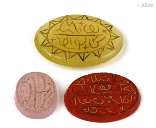 An Islamic carved hardstone matrix seal; together with two similar with inlaid gold Islamic