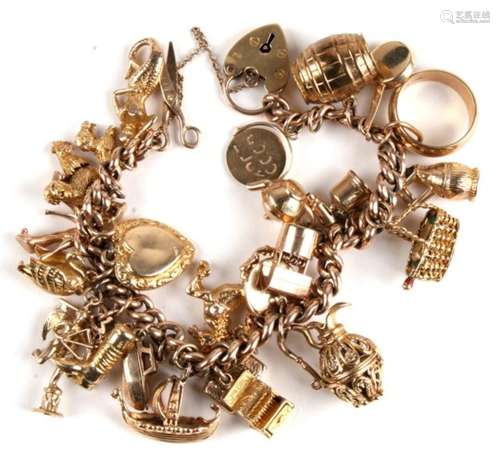 A 9ct rose gold charm bracelet with twenty seven charms. 72.5g.