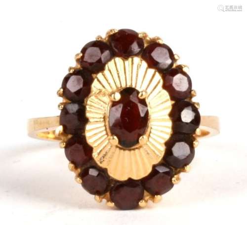 An 18ct gold garnet cluster ring. Approx. UK size M