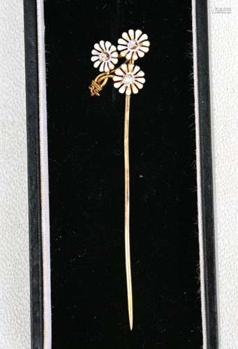 A French 18ct gold diamond and enamel stick pin in the form of a spray of daisies.