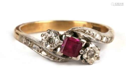 An 18ct gold ruby and diamond crossover ring, approx UK size 'M', 4.04g.