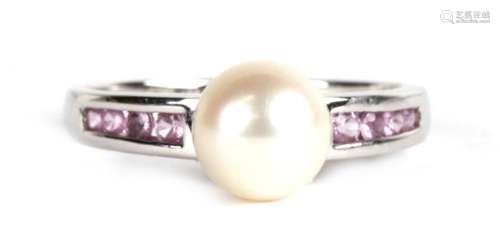 A 9ct white gold ring set with a central pearl and channel set pink tourmaline shoulders, approx