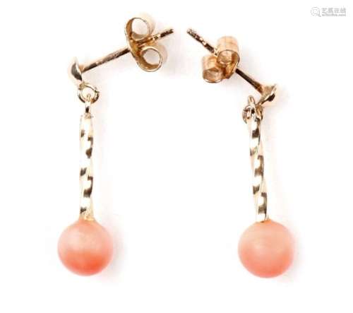 A pair of coral drop earrings.