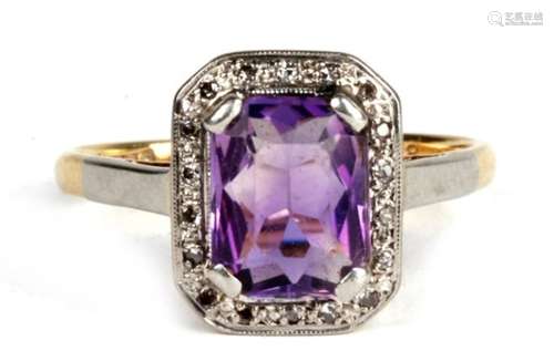 An 18ct gold and platinum ring , with central amethyst surrounded by diamond chips. 3.8g