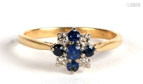 An 18ct gold and sapphire cross design cluster ring, 2.5g. Approx.. UK size O