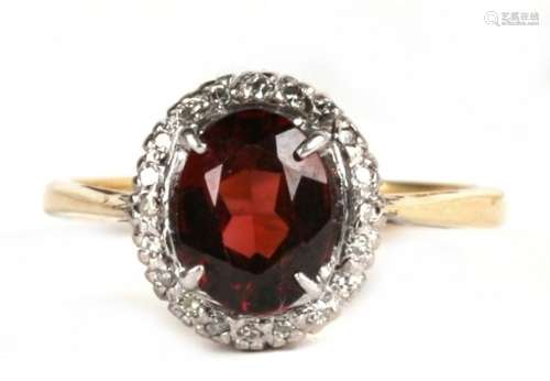 An 18ct gold, garnet and diamond cluster ring, 3.5g. Approx. UK size M.