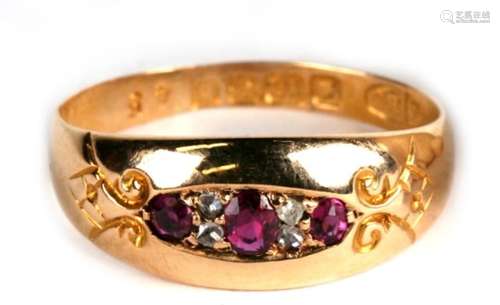 An 18ct gold, ruby and diamond 7 stone ring, Birmingham 1907, 2.4g. Approx. UK size O.