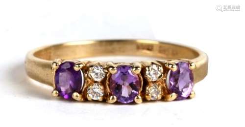 A 14ct gold, three amethyst and four white sapphire ring, 2.7g. Approx. UK size P.