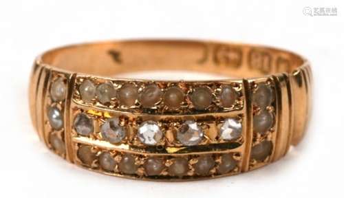 An early 20th century 18ct gold ring set with a line of old cut diamonds surrounded by a border of