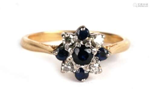 An 18ct gold, diamond and sapphire daisy head ring, 3.1g. Approx. UK size K,