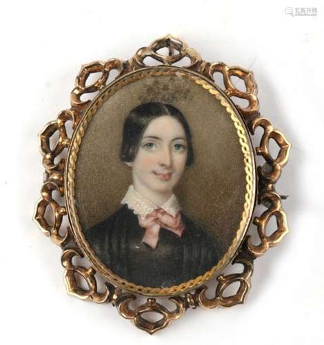 A 19th century glazed back portrait miniature brooch of a young girl, within a pierced 9ct gold