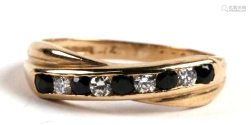 A 9ct gold, sapphire and CZ nine stone crossover ring, 2.0g. Approx. UK size L.