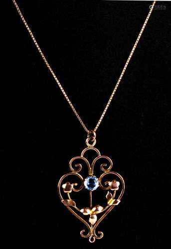 An ornate Edwardian 9ct gold pendant on chain, set with a single central topaz. weight 3.1g. Chain