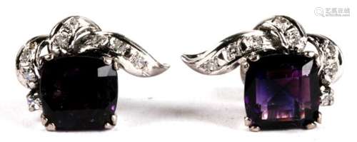 A pair of 14ct white gold earrings modelled as a flower, each set with a central square amethyst and