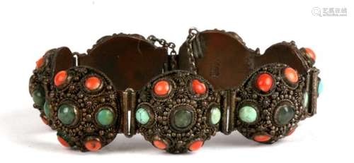 A Chinese seven panel bracelet, each set with central jade cabochon within a border of turquoise and