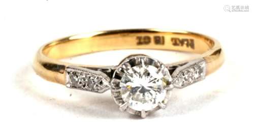 An 18ct gold, platinum and diamond ring, the central stone approximately 0.3cts, flanked to the