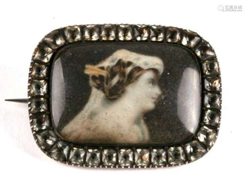 An early Victorian gold mourning brooch, set a glazed en grisaille portrait within a border of