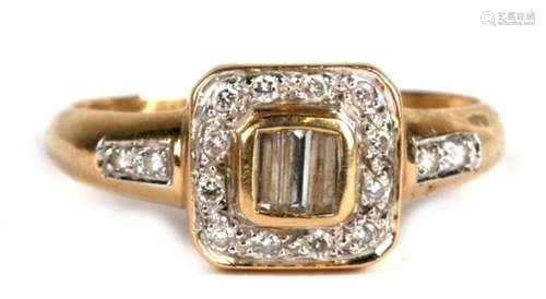 An 18ct gold diamond ring set with three central baguette diamonds surrounded by diamonds, with