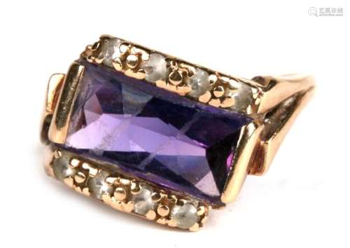 A 9ct gold ring set with a rectangular amethyst flanked by diamonds, approx UK size 'K'.