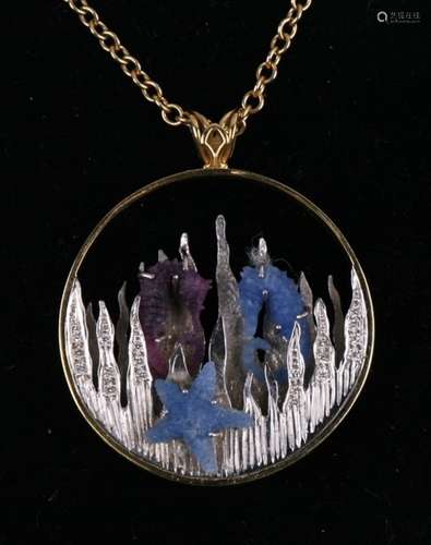 An 18ct yellow and white gold seascape pendent with carved blue sapphire seahorse and starfish and