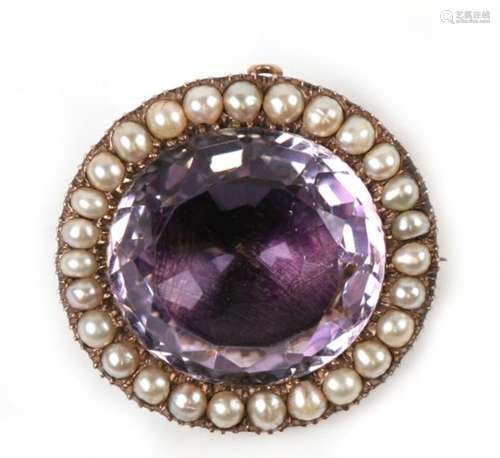 A large gold brooch, the central amethyst surrounded by pearls.