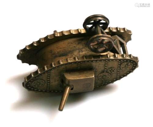 A WW1 cast brass tank with moving machine guns and steering tail wheels. Overall length 13cms (