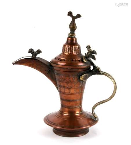 A Turkish / Islamic copper and brass dallah coffee pot, 22cms (8.75ins) high.