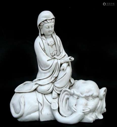 A Chinese Blanc de Chine style figure, depicting Guan Yin seated on an elephant. 30cm 12ins high