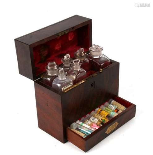 A Victorian flame mahogany apothecary box fitted with bottles and drawer below bearing the maker’s