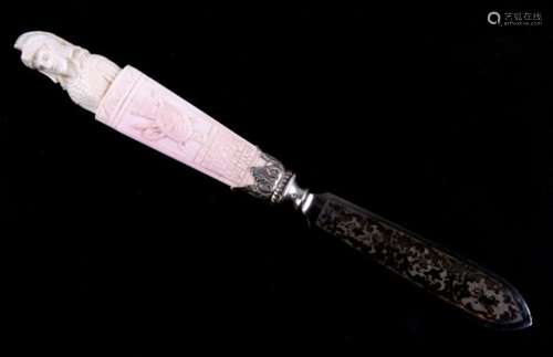 A paperknife with carved coral handle, in the form of a Roman soldier. The steel blade is finely