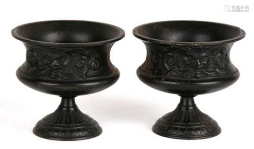 A pair of late 19th century miniature cast iron urns by EG Zimmermann of Hanau, decorated in high