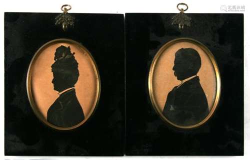 A pair of late 19th century silhouettes in ebonised acorn frames, both bearing labels for Riders