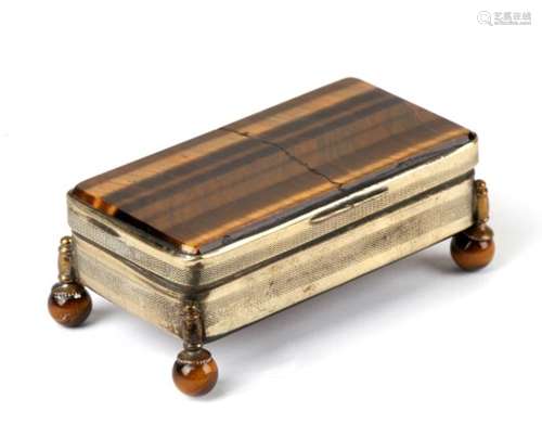 A 19th century three division stamp box set with tiger eye panels to top and bottom, sitting on four