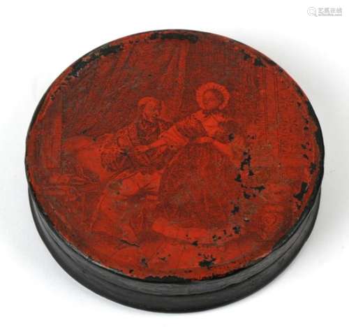 A 19th century circular papier mache snuff box, monochrome decorated with a scene of a courting