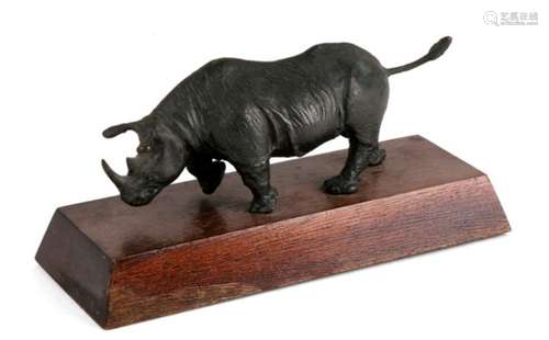 A 20th century cast bronze figure of a walking rhino, unsigned. 14cm (5.5 ins) long