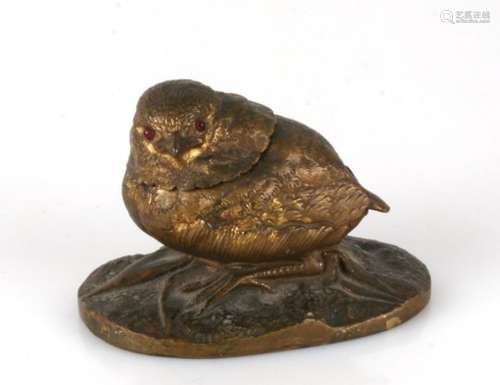 A 19th century novelty bronze inkwell modelled as a seated bird with red glass eyes. 9cm ( 3.5